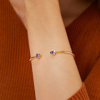 model wearing purple stone gold plated open cuff bracelet
