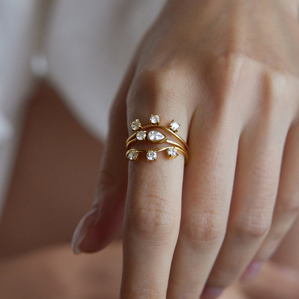 Gold-tone stacked eye motif rings shown on finger
