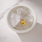 Bypass ring displayed in a dish of decorative clear stones