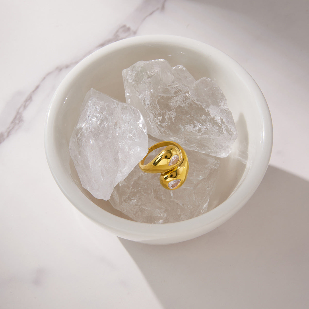 Bypass ring displayed in a dish of decorative clear stones