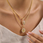 Oval and sunburst portrait medallion necklaces layered on model