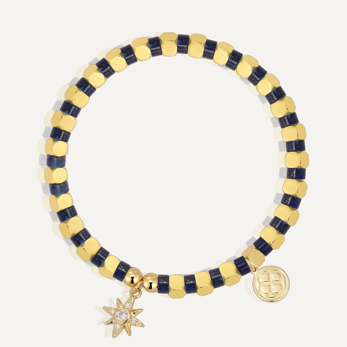 gold plated starburst charm bracelet with dark blue cube beads