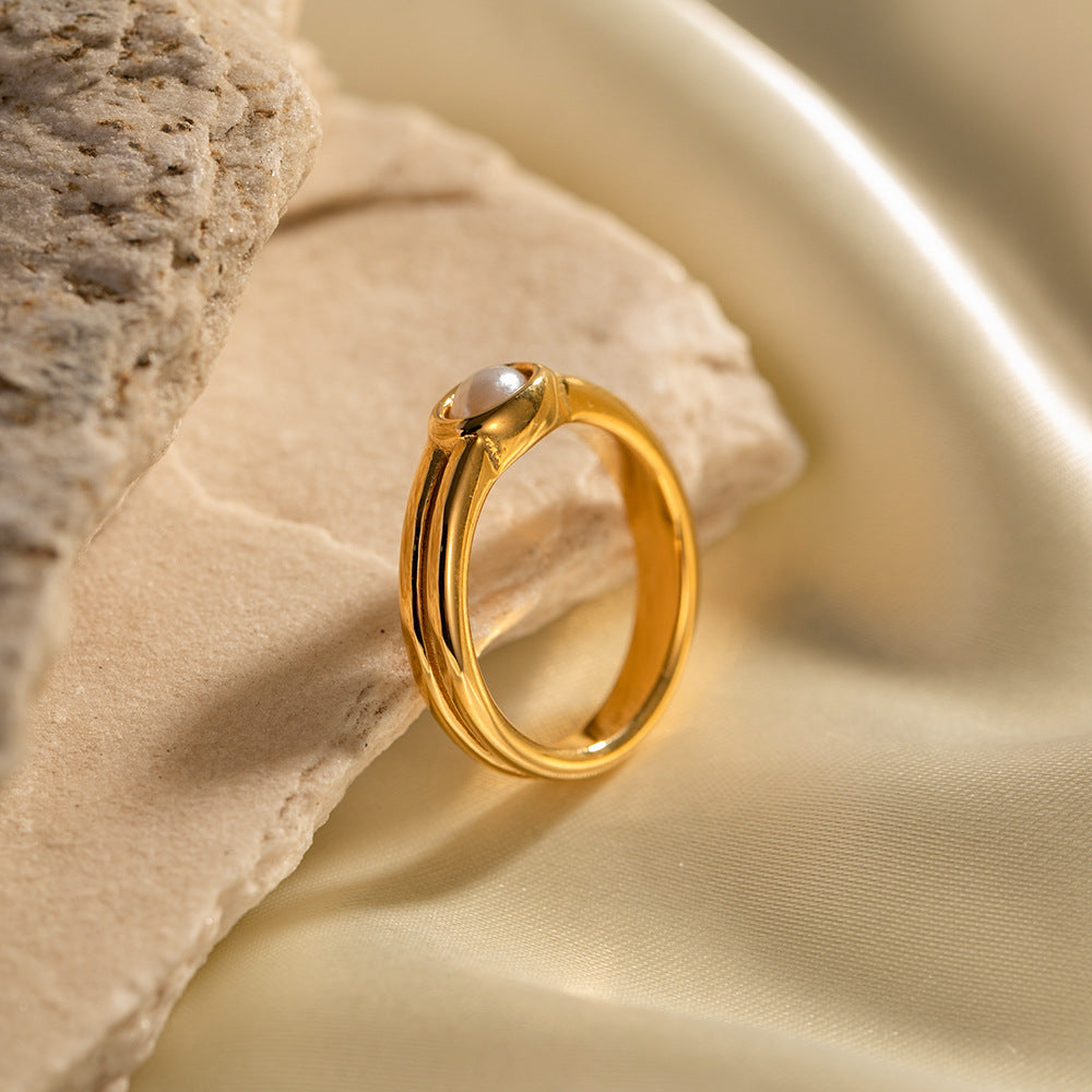 Gold plated white oval double-band ring in a styled display