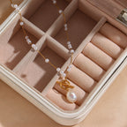 asymmetrical white bead station necklace displayed in a jewelry case