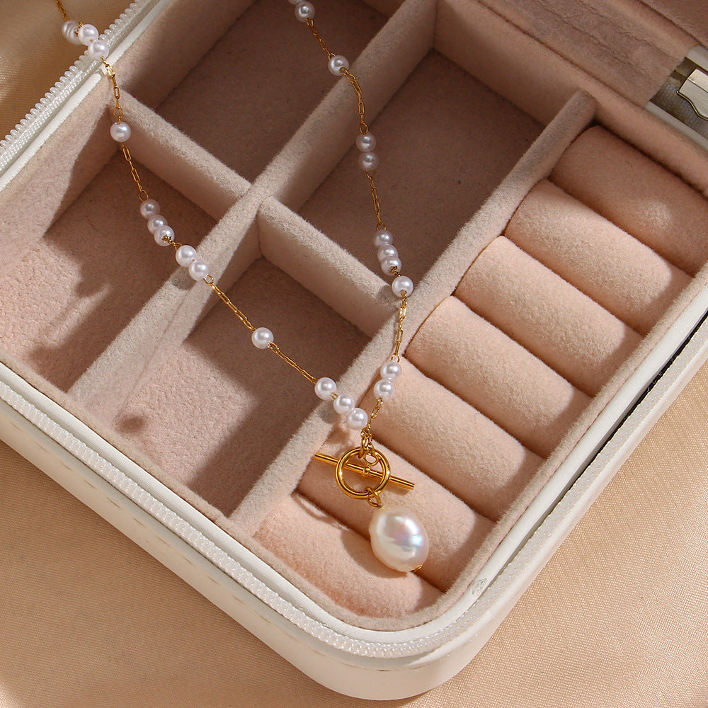 asymmetrical white bead station necklace displayed in a jewelry case