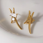 Curved stainless steel studs resting on a white dish
