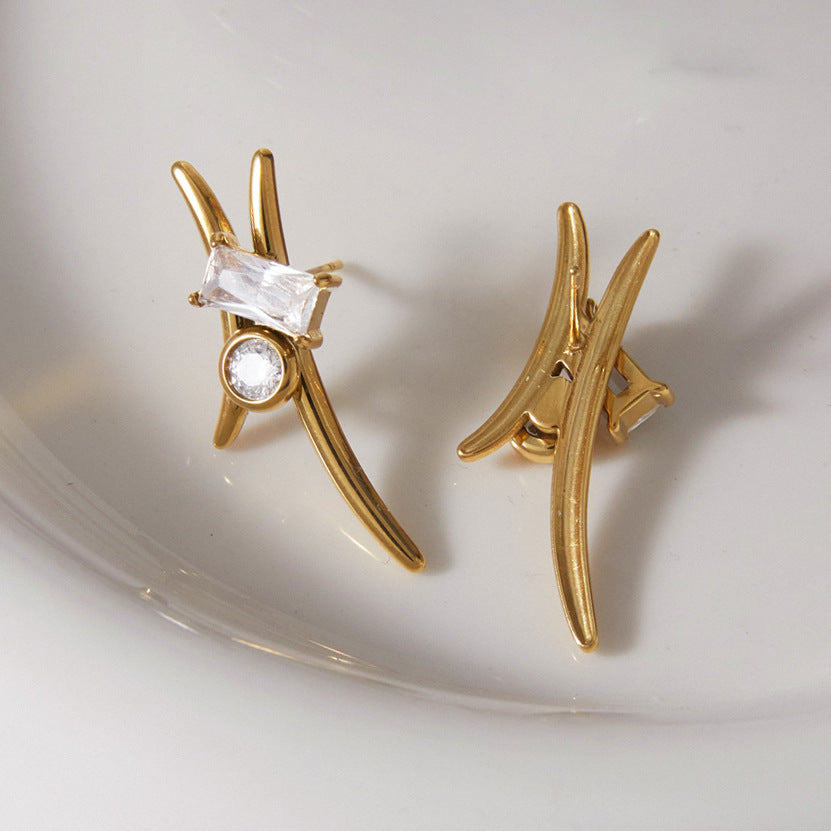 Curved stainless steel studs resting on a white dish