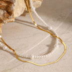 Close-up of pearl-look bead stations beside the flat chain
