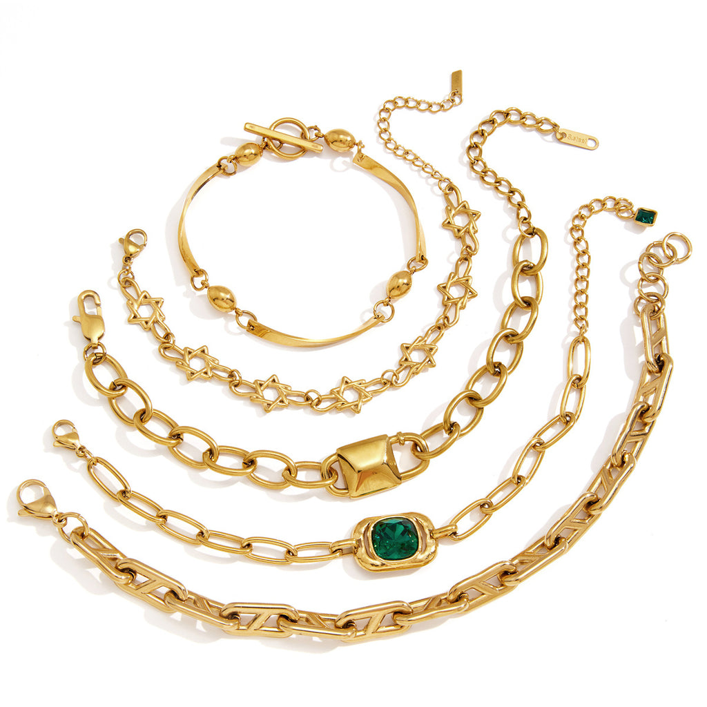 Gold-tone bracelet assortment arranged on white