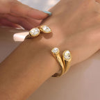 Gold tone tapered cuffs shown together on model