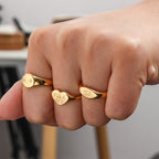 Three slogan rings worn on fingers
