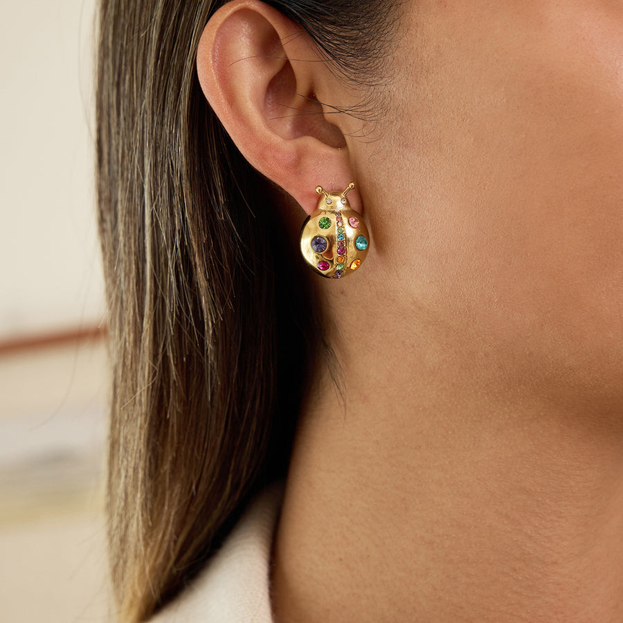 gold plated multicolor ladybug stud earrings worn on ear