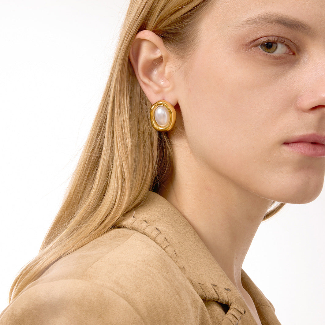 Gold Tone Pearl-Look Stainless Steel Oval Stud Earrings — angled view showing the sculptural rim