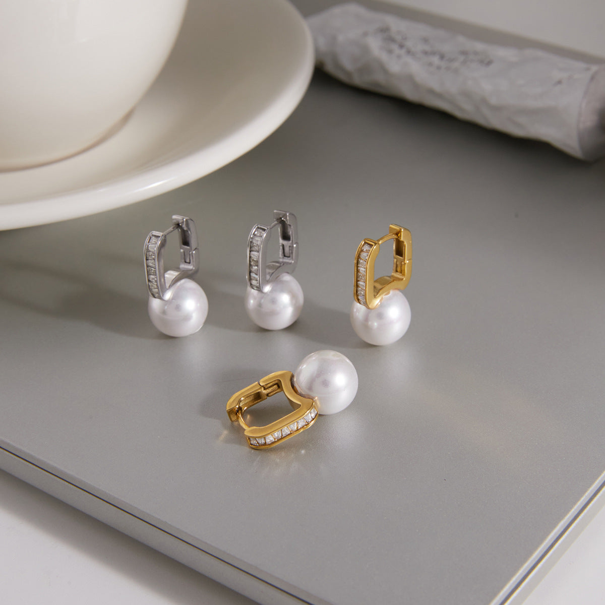 gold plated and silver-finish huggie earrings with white resin pearls