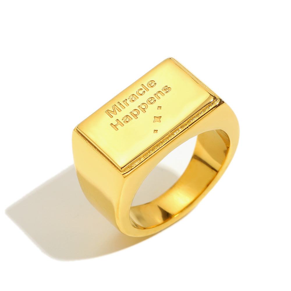 isolated gold plated Miracle Happens message signet ring