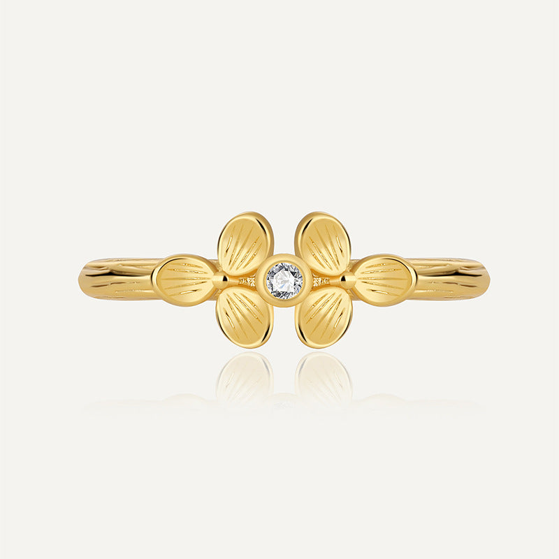 front view of gold plated brass clover ring with clear center stone