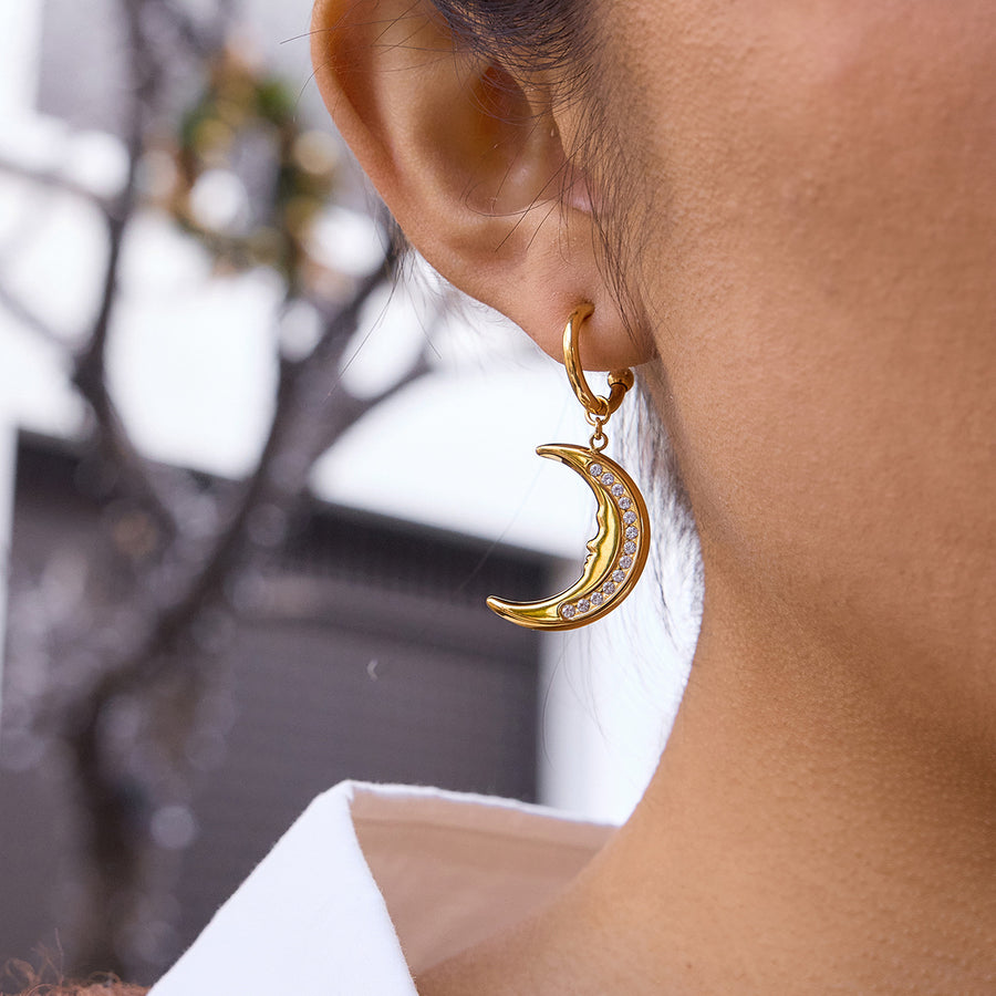 gold plated clear stone crescent moon earring worn in profile