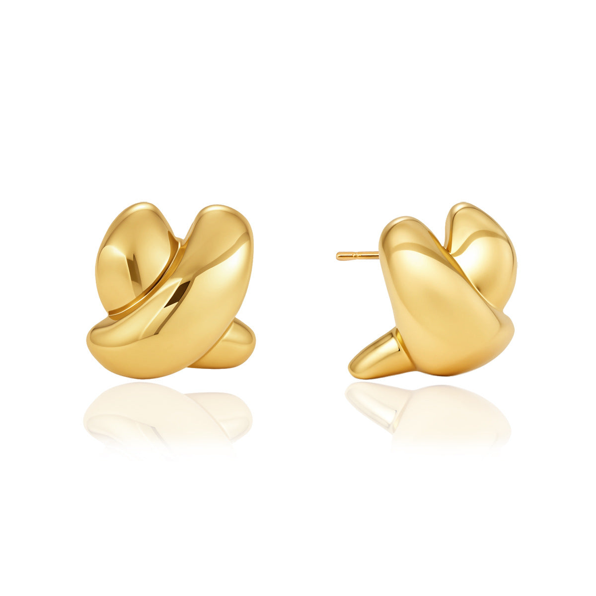 Polished gold-tone crossed curve earrings on white