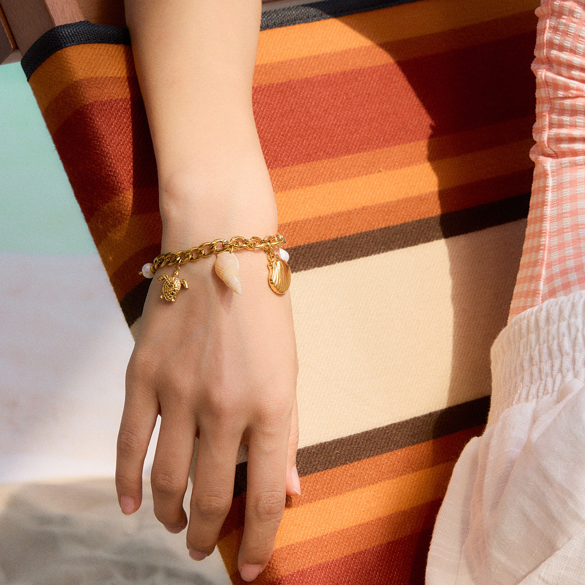 Sea life charm chain bracelet worn on a wrist