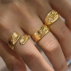 Floral and scroll ring designs worn together