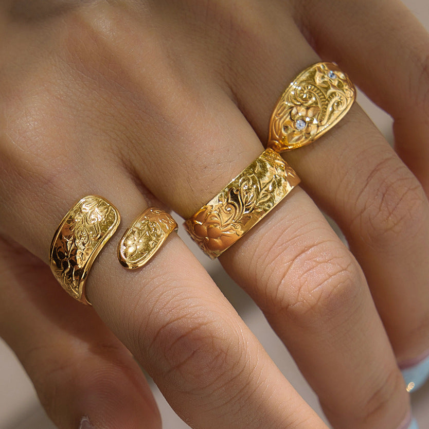 Floral and scroll ring designs worn together