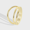 isolated gold plated brass ring with three crossing bands