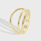 isolated gold plated brass ring with three crossing bands