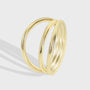isolated gold plated brass ring with three crossing bands