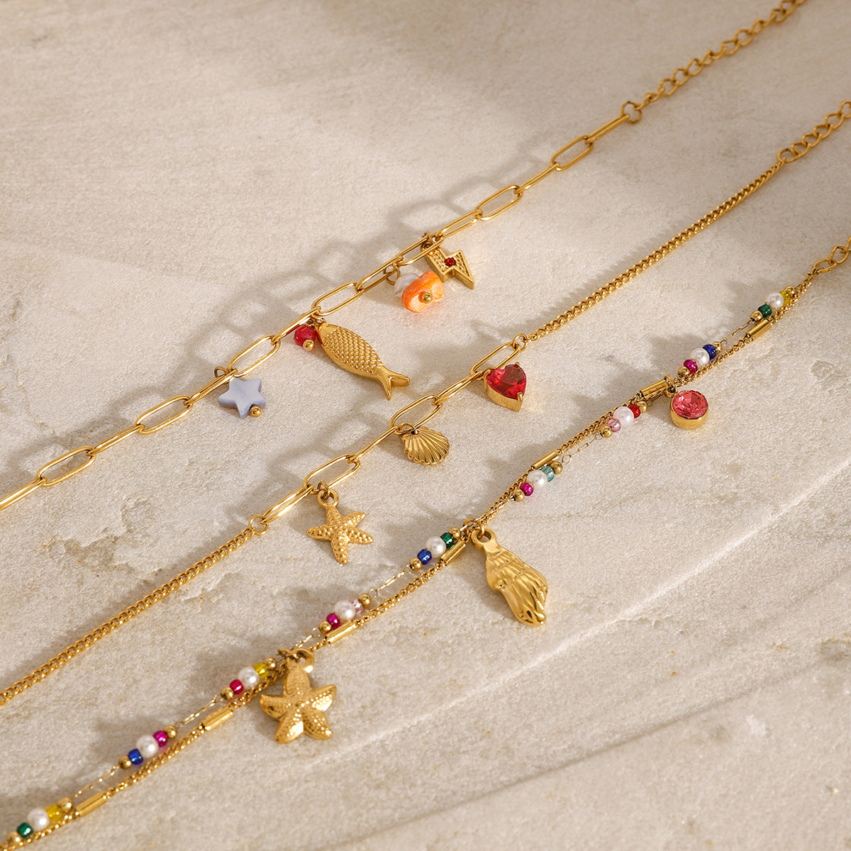 Gold Plated Stainless Steel Ocean Charm Bracelet Collection — front view