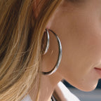 side view of a silver-finish tapered hoop earring
