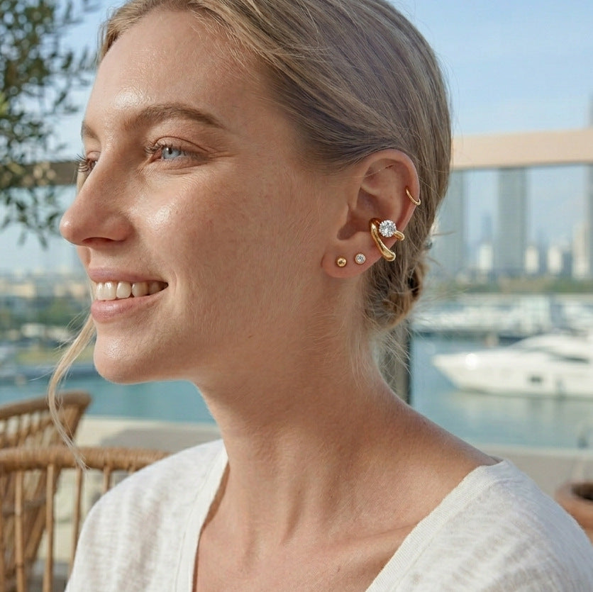 Gold-tone ear cuff styled on a model