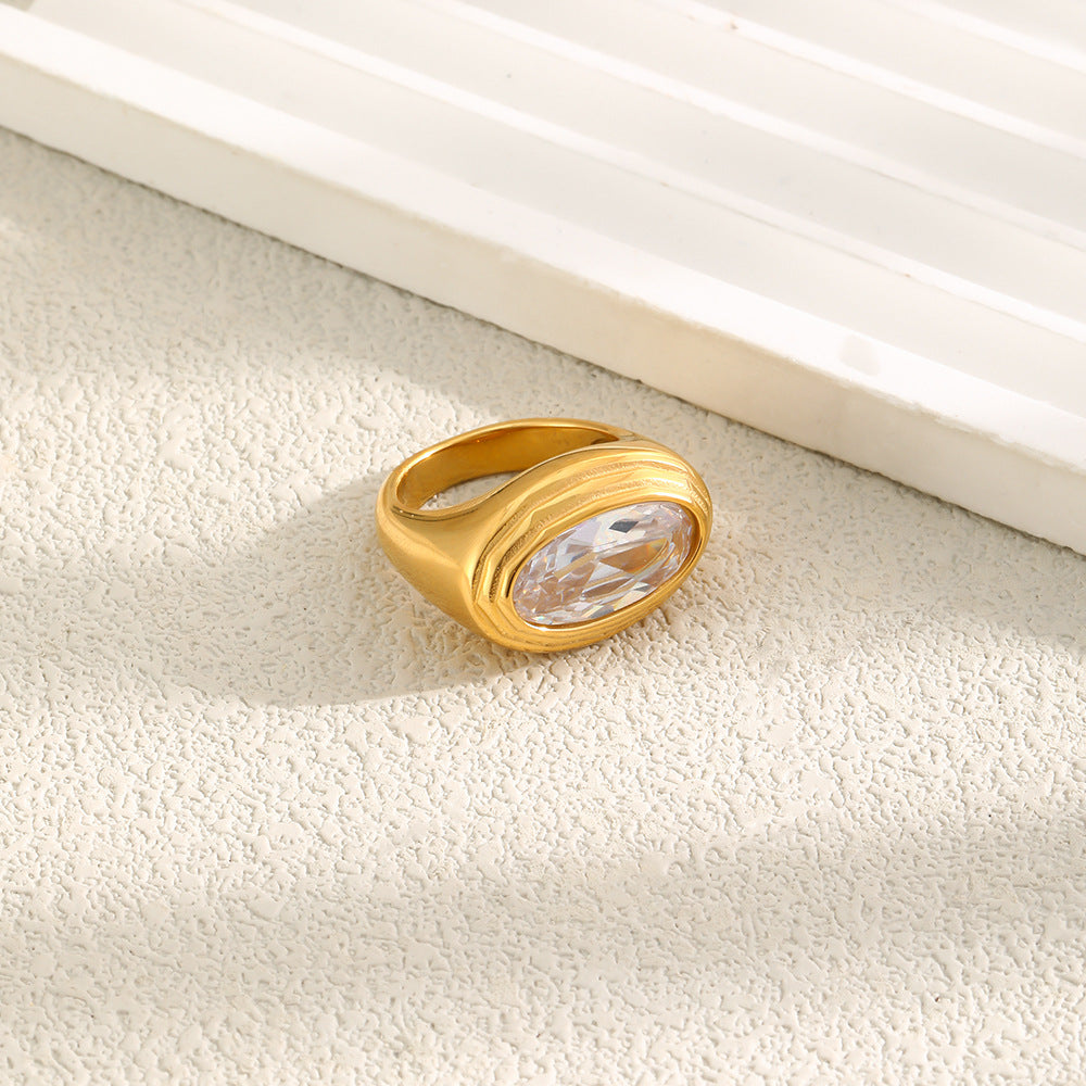 angled oval clear-stone statement ring on a pale surface