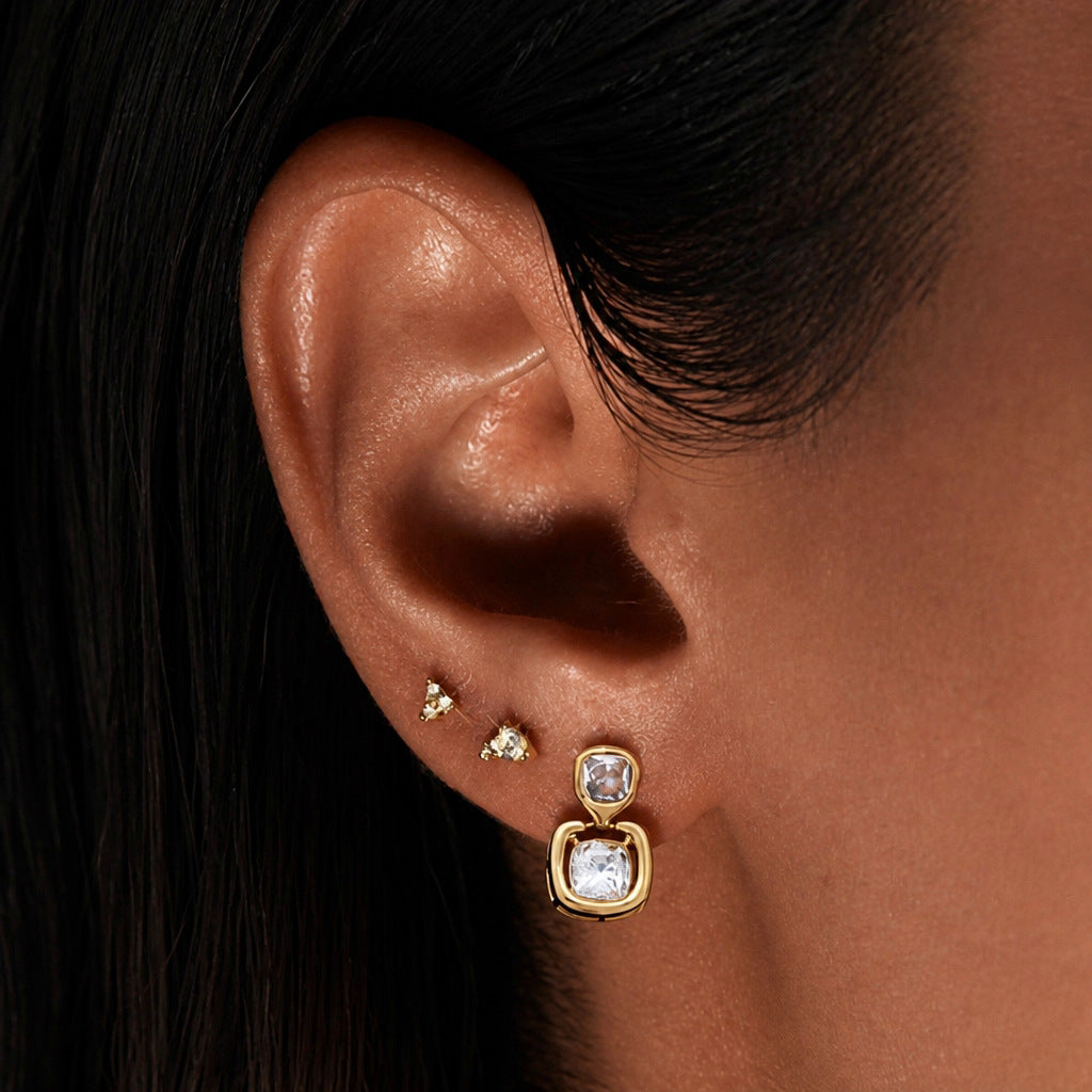 Double cushion drop earring worn with small studs
