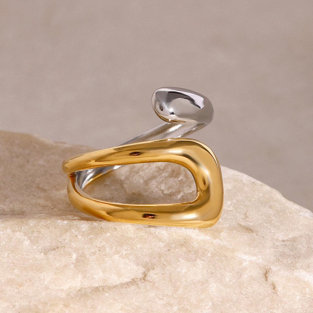 Top view of the asymmetric two-tone open ring on a stone prop