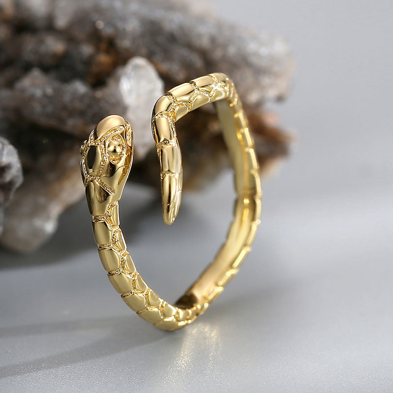 front angle of gold plated snake head and scale-textured body