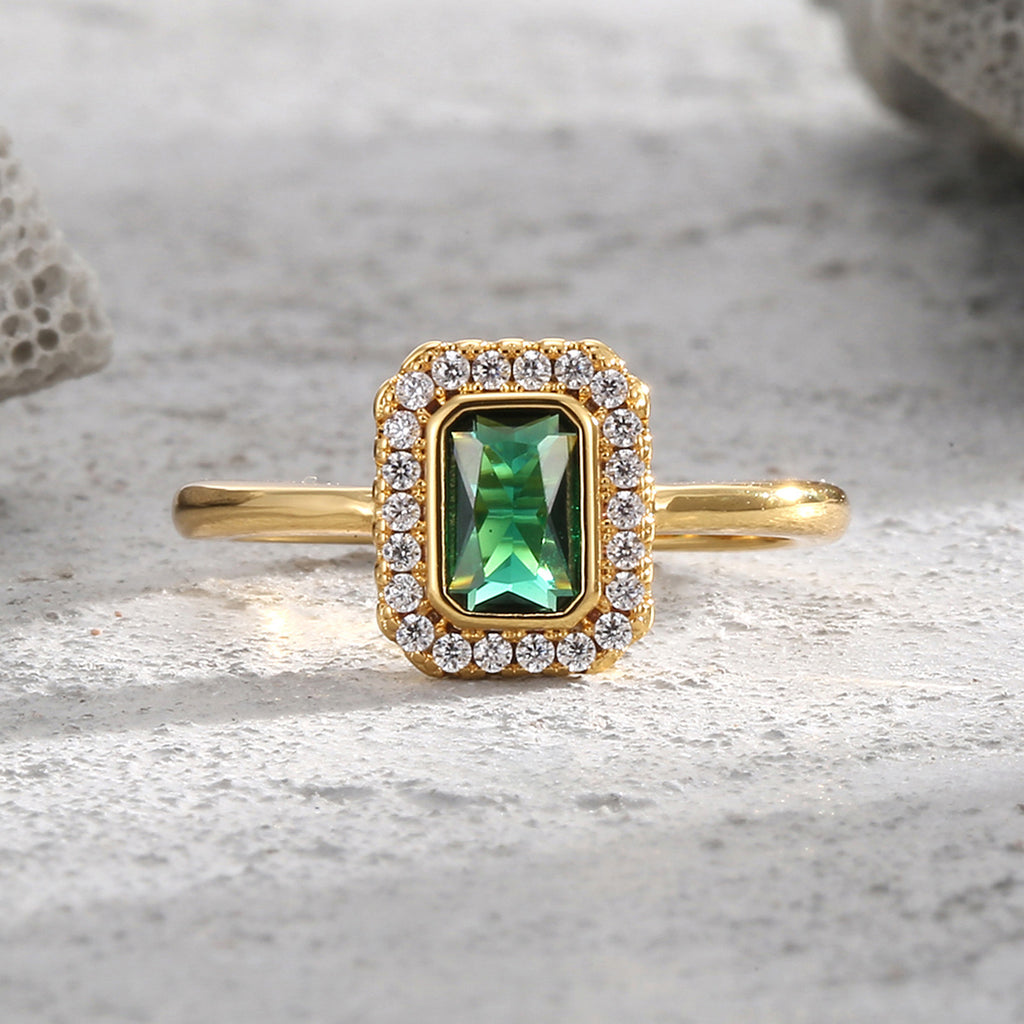 front view of rectangular green zirconia and clear-stone halo ring