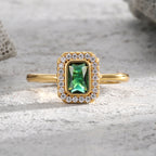 front view of rectangular green zirconia and clear-stone halo ring