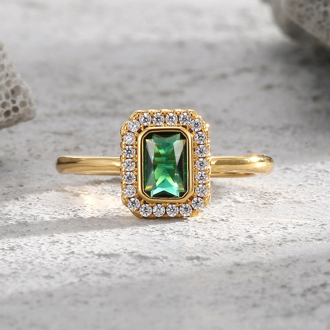 front view of rectangular green zirconia and clear-stone halo ring