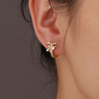925 Sterling Silver Bow Zirconia Huggie Hoop Earrings — gold bow hoop worn on ear
