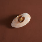 Starfish ring displayed on a shell-shaped surface