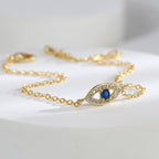 close-up of blue and clear stone evil eye bracelet station