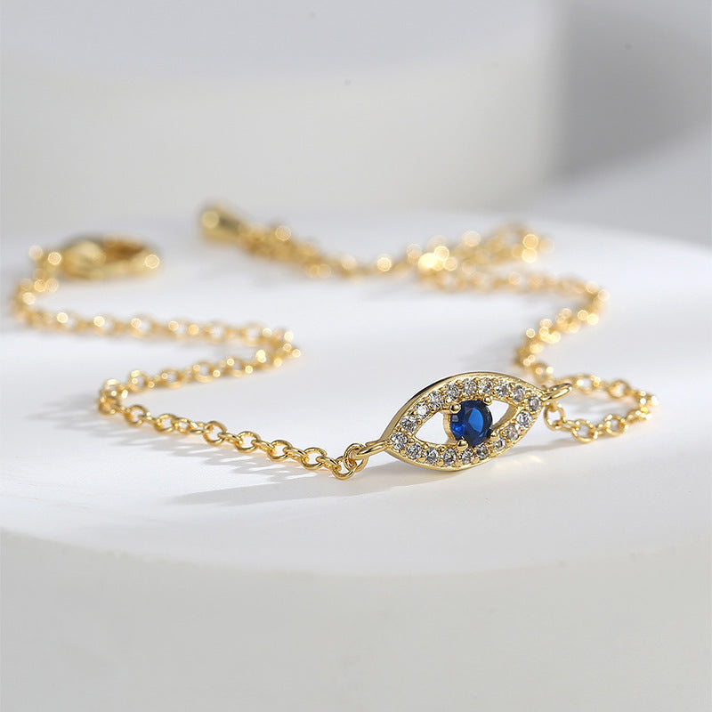 close-up of blue and clear stone evil eye bracelet station