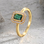 angled green zirconia halo ring on a pale stone surface