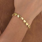 Gold plated stainless steel heart-link bracelet worn on the wrist