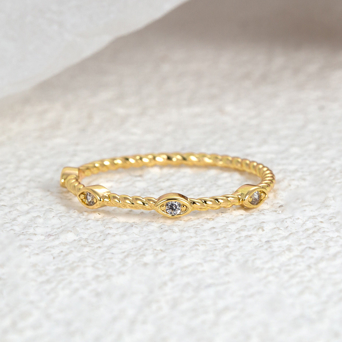 front view of twisted band and center bezel-set clear stone