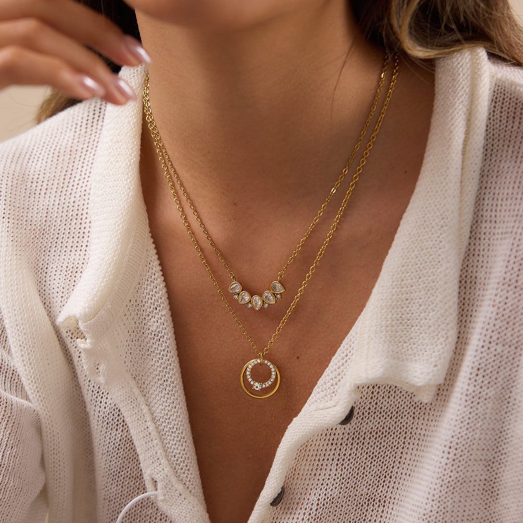 Circle and teardrop-row necklaces worn together