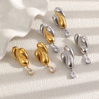 Three metal-color sculptural earring pairs displayed together