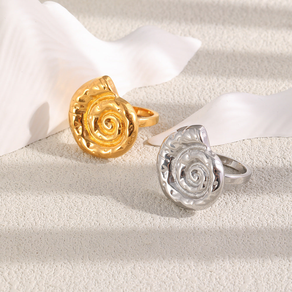 Two shell ring finishes arranged beside a white prop