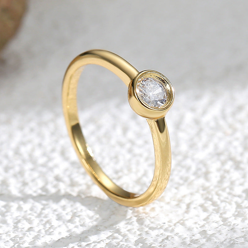 angled close-up of smooth circular bezel and polished ring band