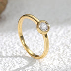 angled close-up of smooth circular bezel and polished ring band